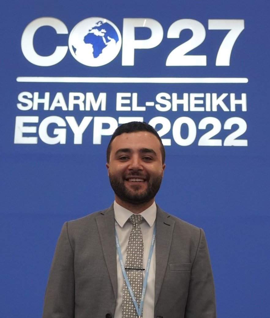 Mohamed Abdelsalam at COP27 in Sharm El-Sheikh, wearing a UNFCCC volunteer badge